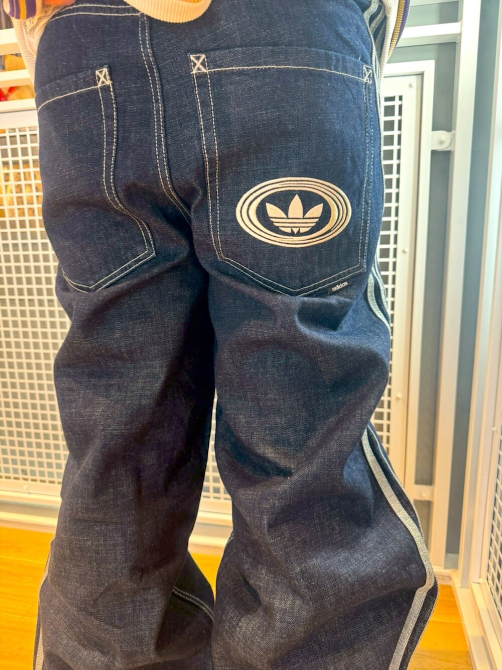 ホワイト系のTシャツ/カットソー、ブルー系のその他パンツ、ブラック系のスニーカーを着用したメンズの冬コーディネートの4枚目の写真