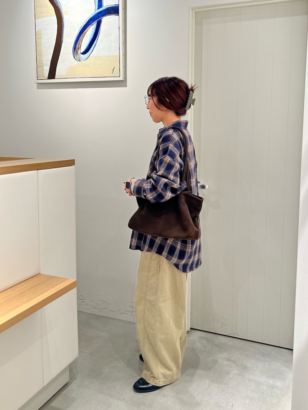 グレー系のTシャツ/カットソー、ブルー系のシャツ/ブラウス、ブラウン系のショルダーバッグを着用したレディースの秋コーディネートの2枚目の写真