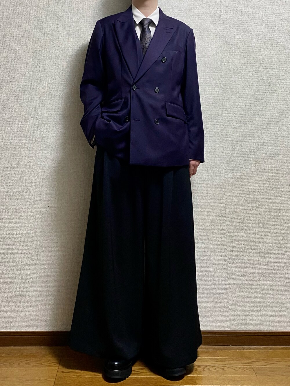 ブラック系のスラックス、ブラック系のドレスシューズ、パープル系のテーラードジャケットを着用したメンズの春コーディネートの3枚目の写真