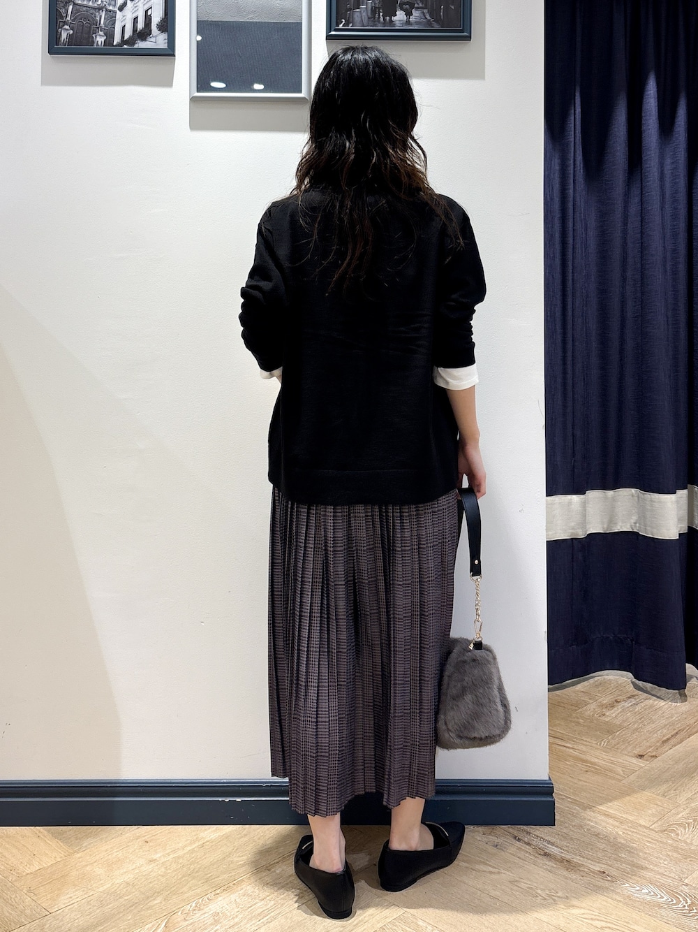ブラック系のカーディガン/ボレロ、ホワイト系のTシャツ/カットソー、グレー系のスカートを着用したレディースの秋コーディネートの3枚目の写真