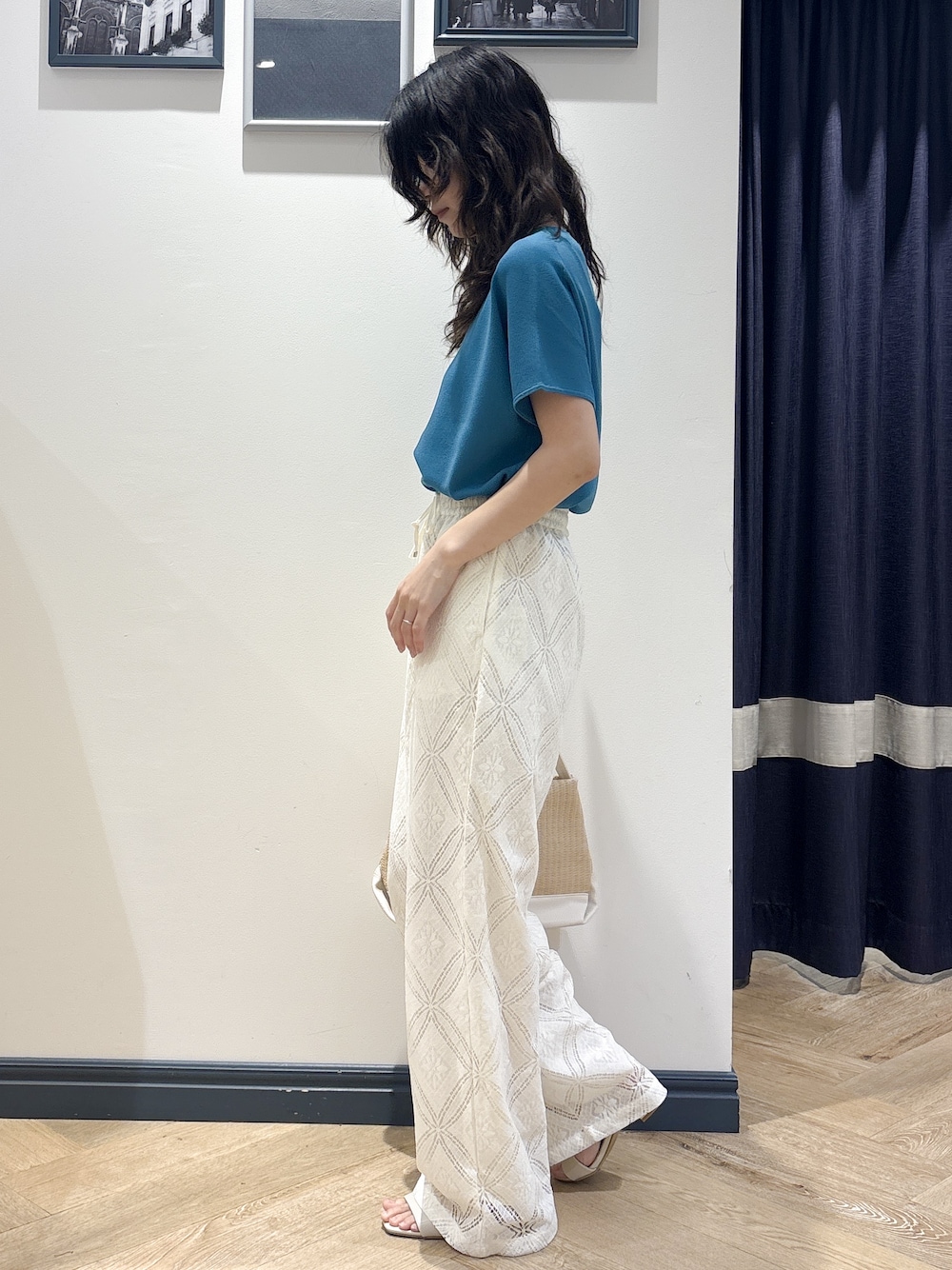 ブルー系のニット/セーター、ホワイト系のその他パンツ、ホワイト系のショルダーバッグを着用したレディースの夏コーディネートの2枚目の写真