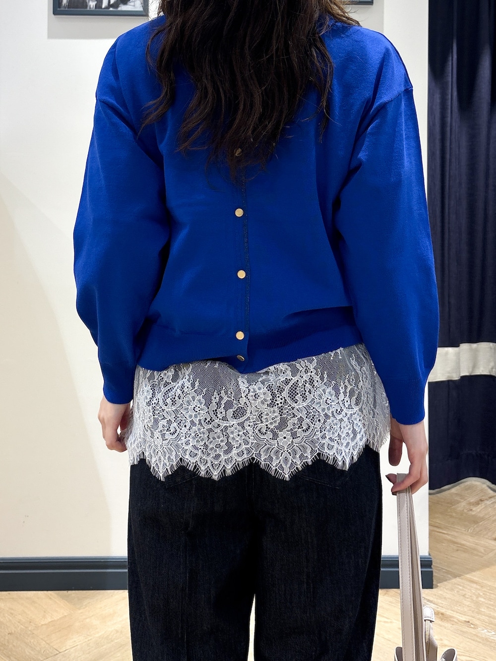 ブルー系のカーディガン/ボレロ、グレー系のTシャツ/カットソー、ブラック系のデニムパンツを着用したレディースの秋コーディネートの5枚目の写真