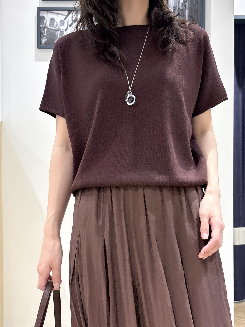 ブラウン系のニット/セーター、ブラウン系のその他パンツ、ブラウン系のショルダーバッグを着用したレディースの春コーディネートの4枚目の写真