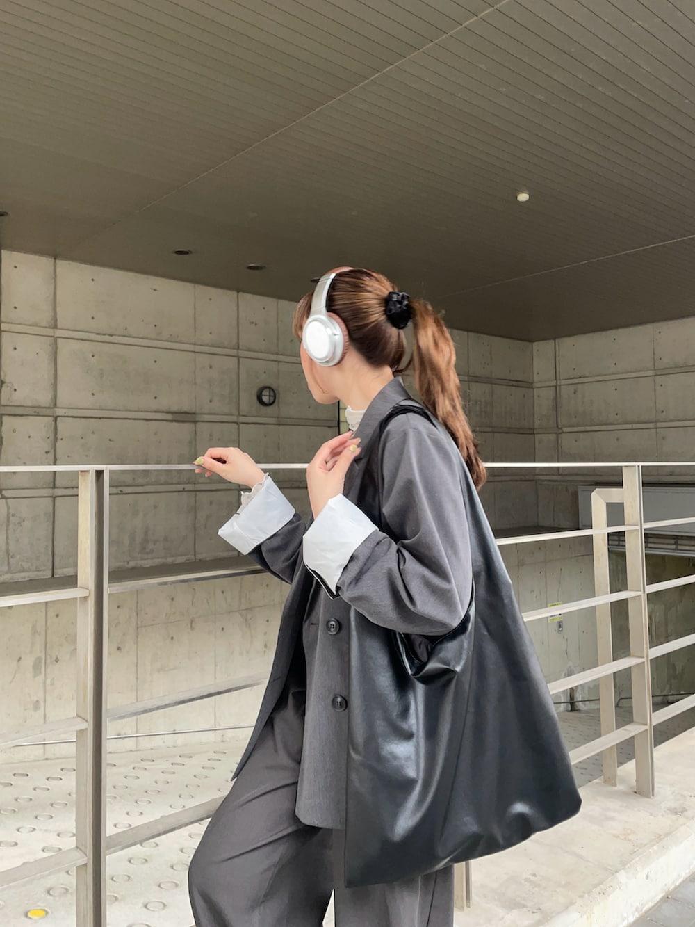ブラック系のトートバッグ、グレー系のテーラードジャケット、ホワイト系のTシャツ/カットソーを着用したレディースの春コーディネートの4枚目の写真