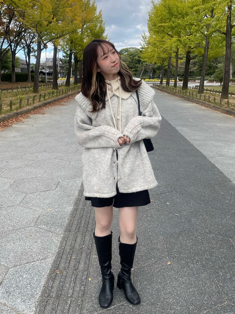 ブラック系のブーツ、グレー系のニット/セーター、ブラック系のパンツを着用したレディースの秋コーディネートの3枚目の写真