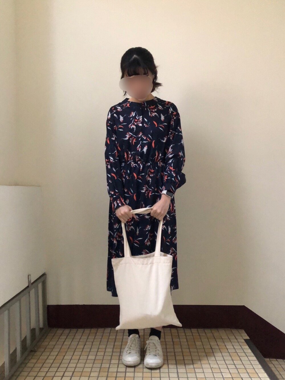 ホワイト系のスニーカー、ブラック系のワンピースを着用したレディースの春コーディネートの2枚目の写真