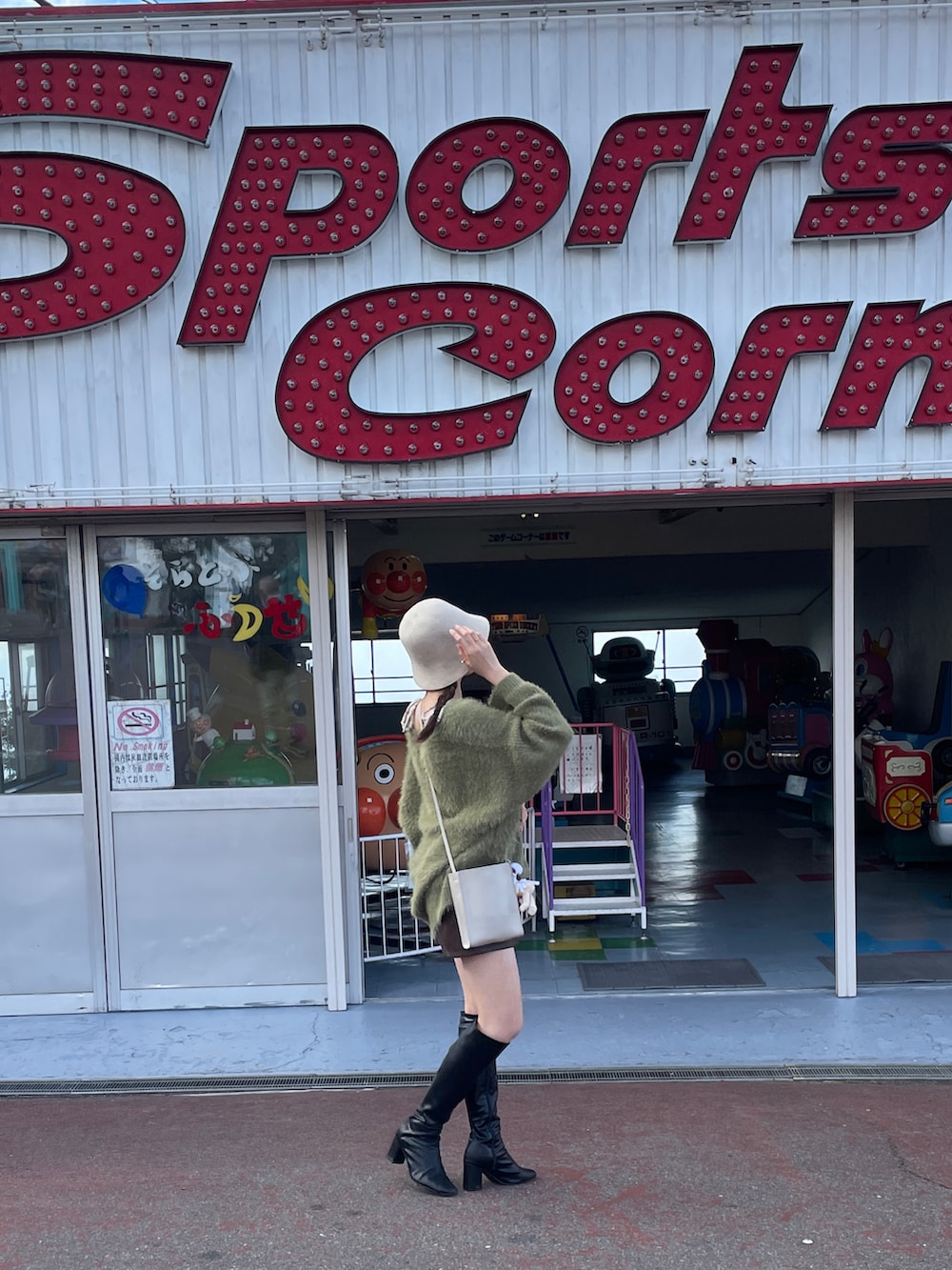 ブラック系のブーツ、グレー系のショルダーバッグ、グリーン系のカーディガン/ボレロを着用したレディースの秋コーディネートの5枚目の写真