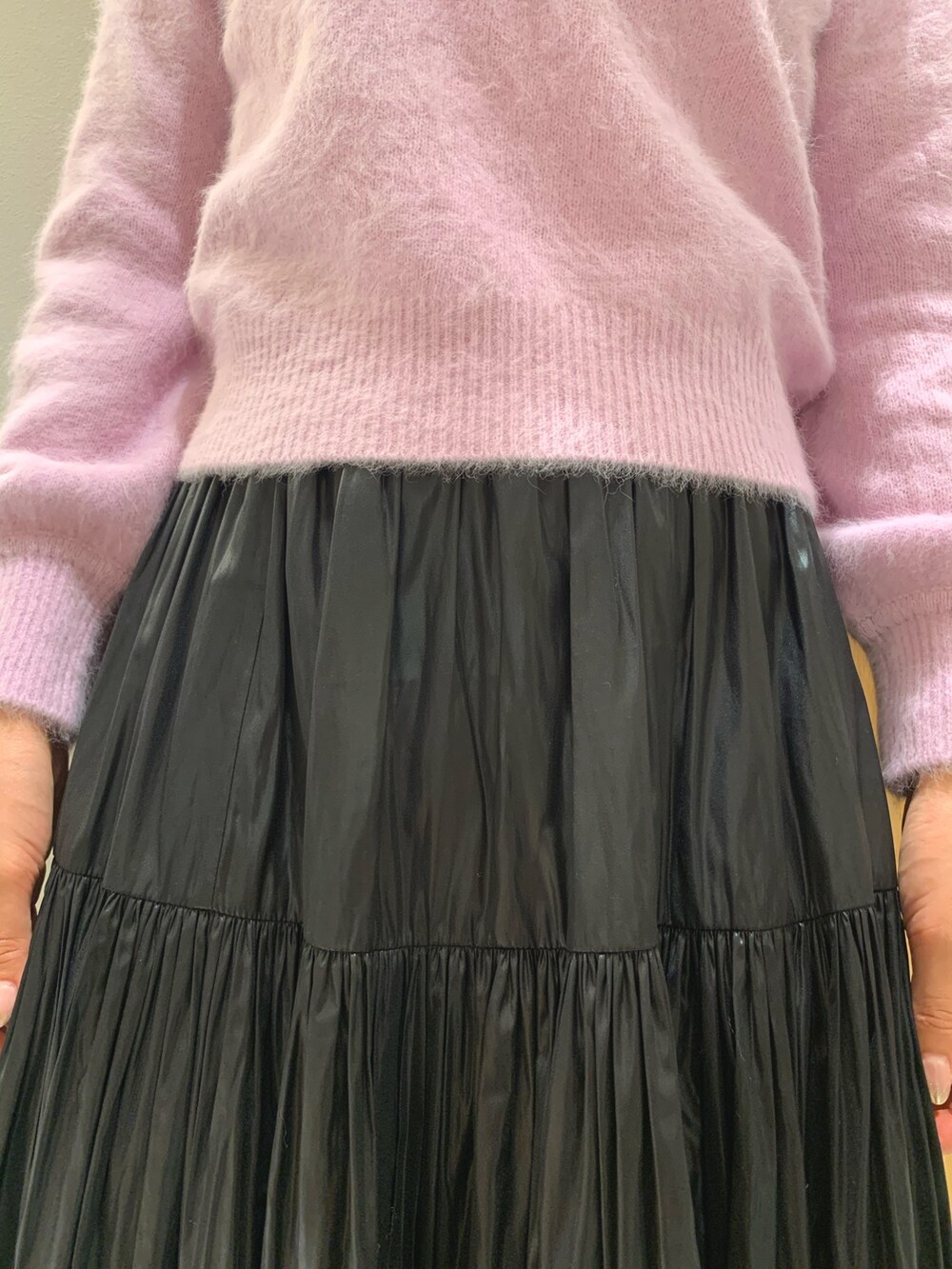 グレー系のハンドバッグ、ブラック系のスカート、パープル系のニット/セーターを着用したレディースの冬コーディネートの7枚目の写真