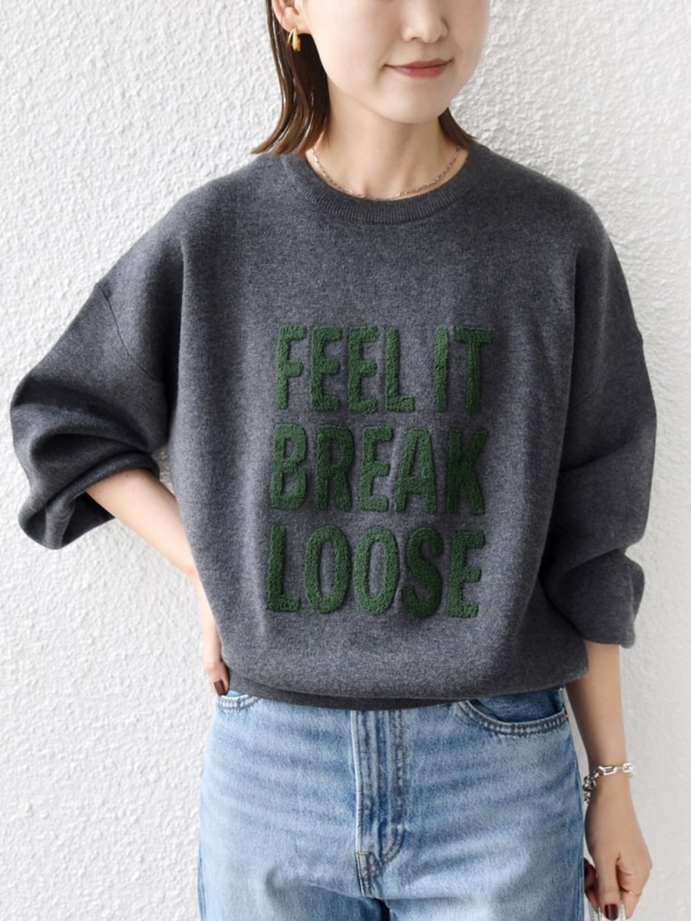 ブルー系のデニムパンツ、グレー系のニット/セーターを着用したレディースの秋コーディネートの4枚目の写真