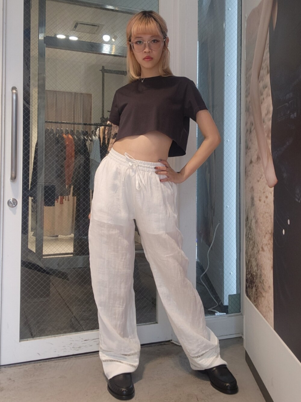ブラック系のTシャツ/カットソー、ホワイト系のその他パンツ、ブラック系のトートバッグを着用したレディースの夏コーディネートの2枚目の写真