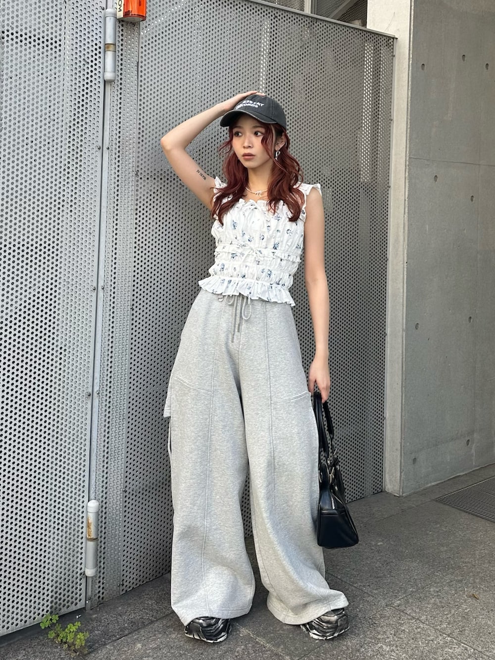 ホワイト系のシャツ/ブラウス、グレー系のスウェットパンツ、ブラック系のハンドバッグを着用したレディースの春コーディネートの2枚目の写真