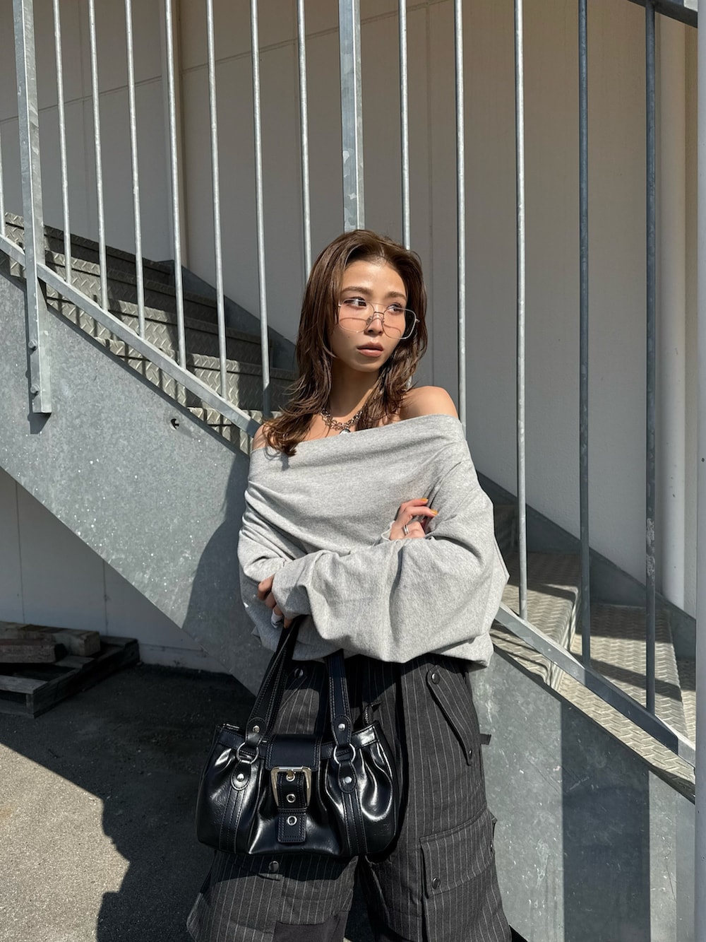 グレー系のスウェット、グレー系のカーゴパンツ、ブラック系のスニーカーを着用したレディースの冬コーディネートの3枚目の写真