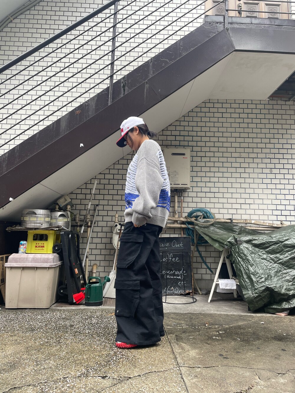 グレー系のニット/セーター、ブラック系のカーゴパンツを着用したレディースの秋コーディネートの4枚目の写真