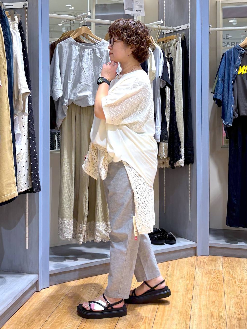 ホワイト系のTシャツ/カットソー、イエロー系のトートバッグ、ブラック系のサンダルを着用したレディースの夏コーディネートの4枚目の写真