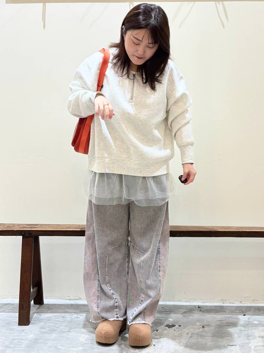 ホワイト系のTシャツ/カットソー、グレー系のデニムパンツ、オレンジ系のショルダーバッグを着用したレディースの秋コーディネートの3枚目の写真