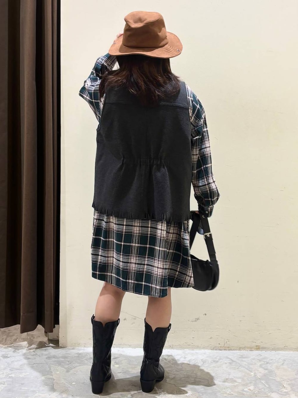 グリーン系のシャツ/ブラウス、ブラック系のブーツ、グレー系のベストを着用したレディースの秋コーディネートの6枚目の写真