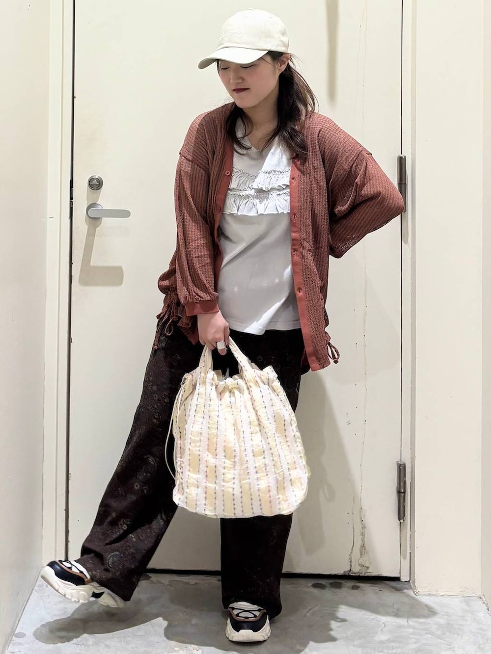 ブラウン系のカーディガン/ボレロ、ベージュ系のその他パンツ、その他のスニーカーを着用したレディースの夏コーディネートの2枚目の写真