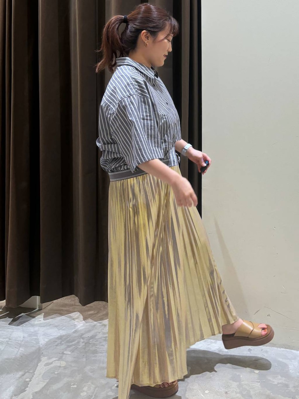 イエロー系のサンダル、イエロー系のスカート、グレー系のシャツ/ブラウスを着用したレディースの夏コーディネートの7枚目の写真