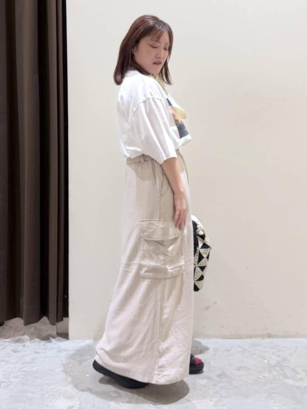 その他のトートバッグ、ベージュ系のスカート、ブラック系のサンダルを着用したレディースの夏コーディネートの4枚目の写真