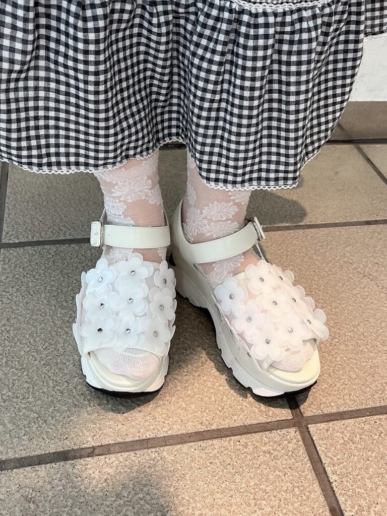 ホワイト系のサンダル、ホワイト系のTシャツ/カットソー、ブラック系のスカートを着用したレディースの夏コーディネートの5枚目の写真