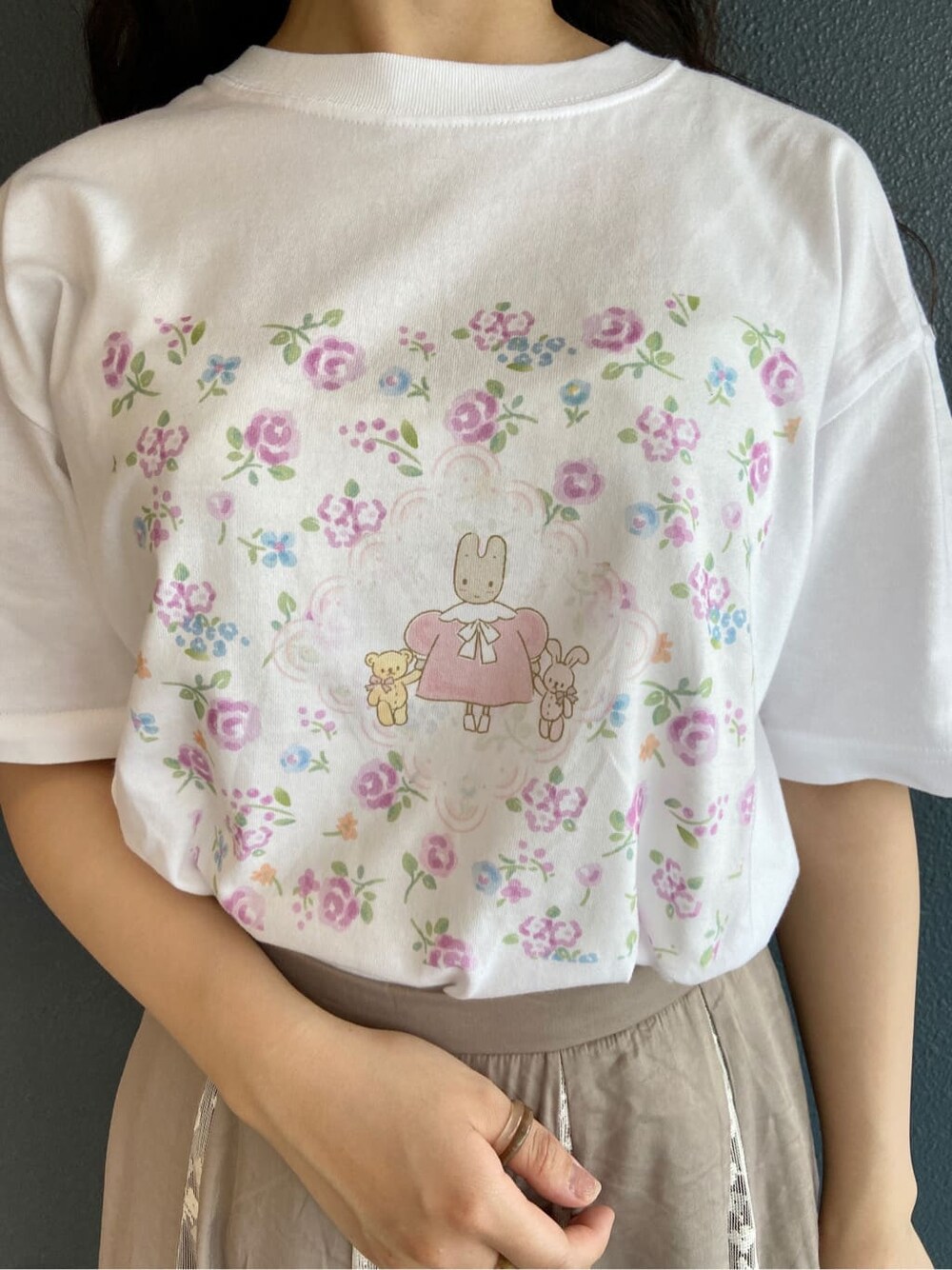 ベージュ系のスカート、ホワイト系のパンプス、ホワイト系のトートバッグを着用したレディースの夏コーディネートの5枚目の写真