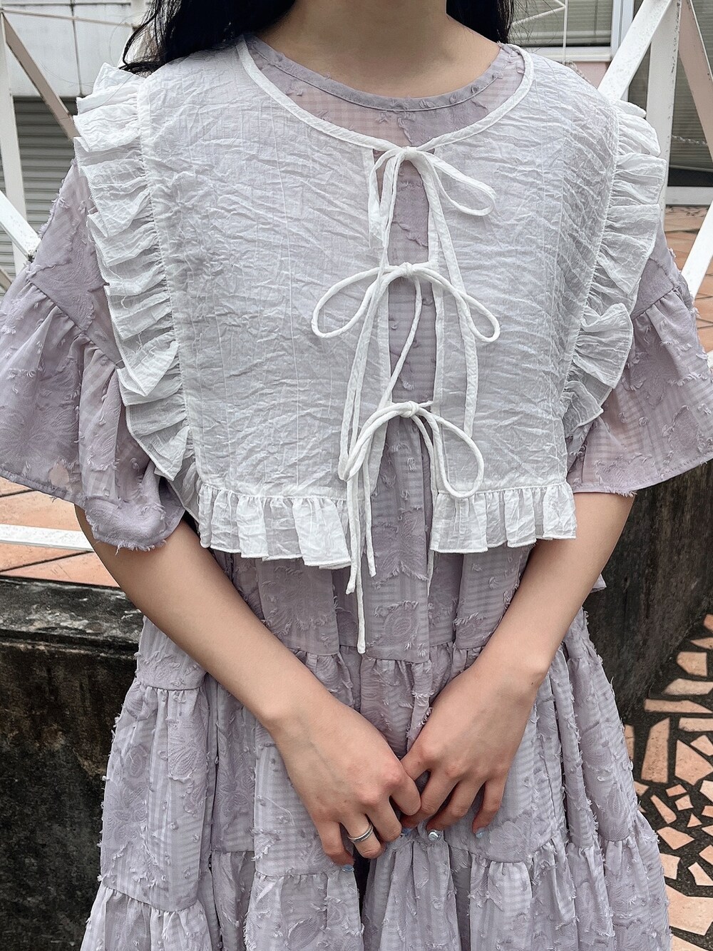 パープル系のワンピース、ホワイト系のスラックス、ブルー系のサンダルを着用したレディースの春コーディネートの5枚目の写真