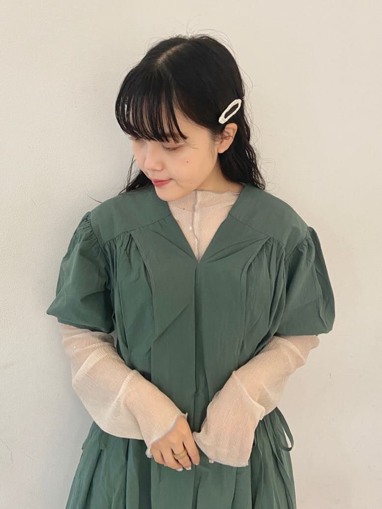 ベージュ系のパンプス、グリーン系のワンピース、ホワイト系のチュニックを着用したレディースの夏コーディネートの4枚目の写真