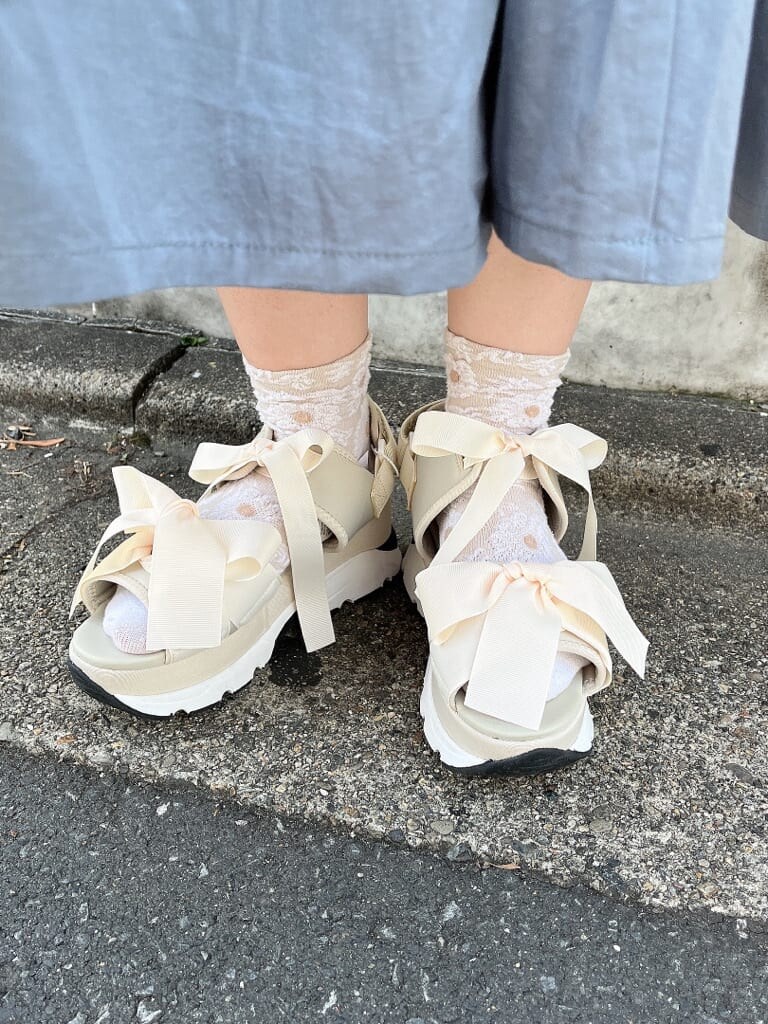 ホワイト系のショルダーバッグ、ホワイト系のサンダル、ブルー系のワンピースを着用したレディースの夏コーディネートの5枚目の写真