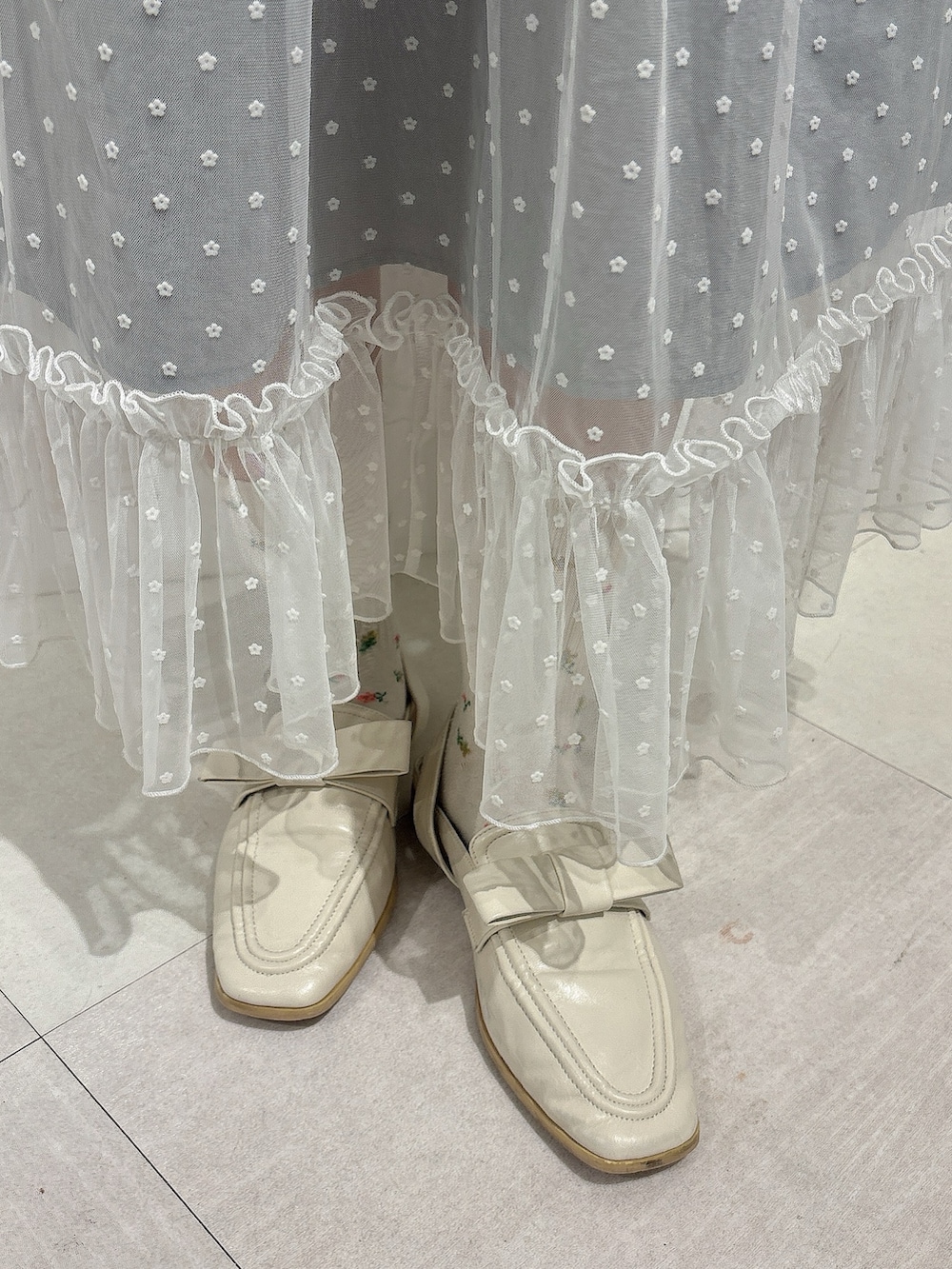 ホワイト系のシャツ/ブラウス、グレー系のワンピース、ホワイト系のローファーを着用したレディースの秋コーディネートの8枚目の写真