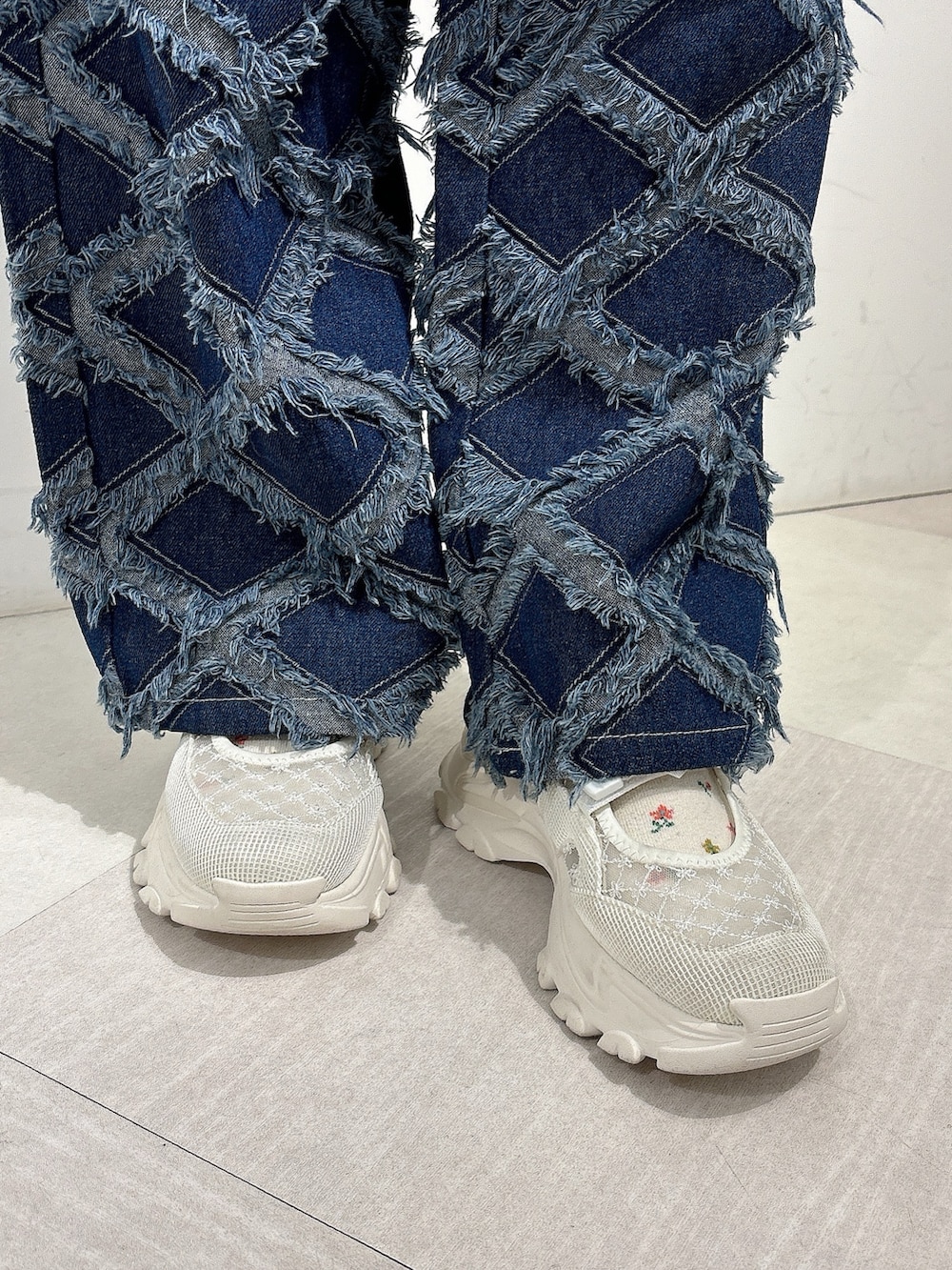 ホワイト系のジャージ、ブルー系のデニムパンツ、ホワイト系のスニーカーを着用したレディースの秋コーディネートの10枚目の写真