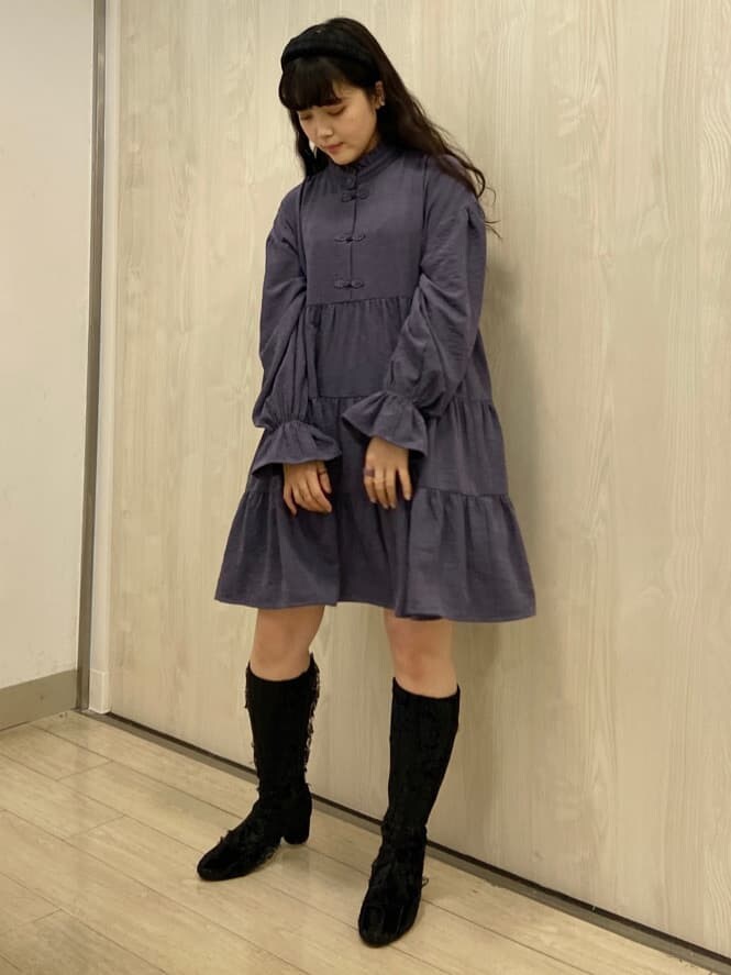 ブルー系のナイロンジャケット、パープル系のワンピース、ブラック系のブーツを着用したレディースの冬コーディネートの3枚目の写真