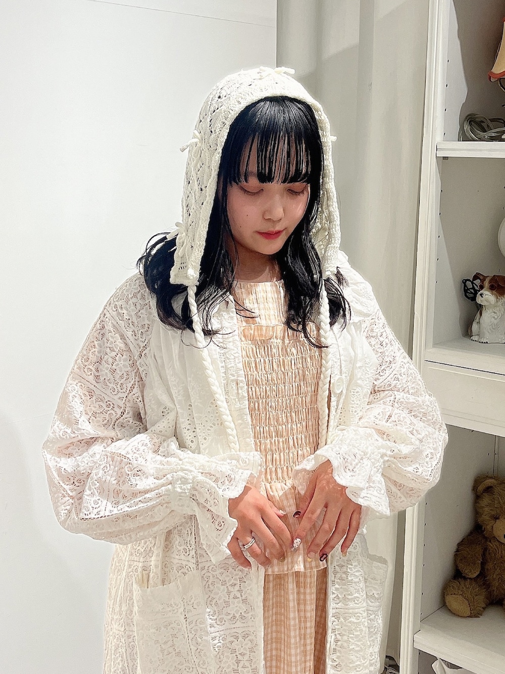 オレンジ系のワンピース、ホワイト系のトレンチコート、ホワイト系のパンプスを着用したレディースの春コーディネートの5枚目の写真