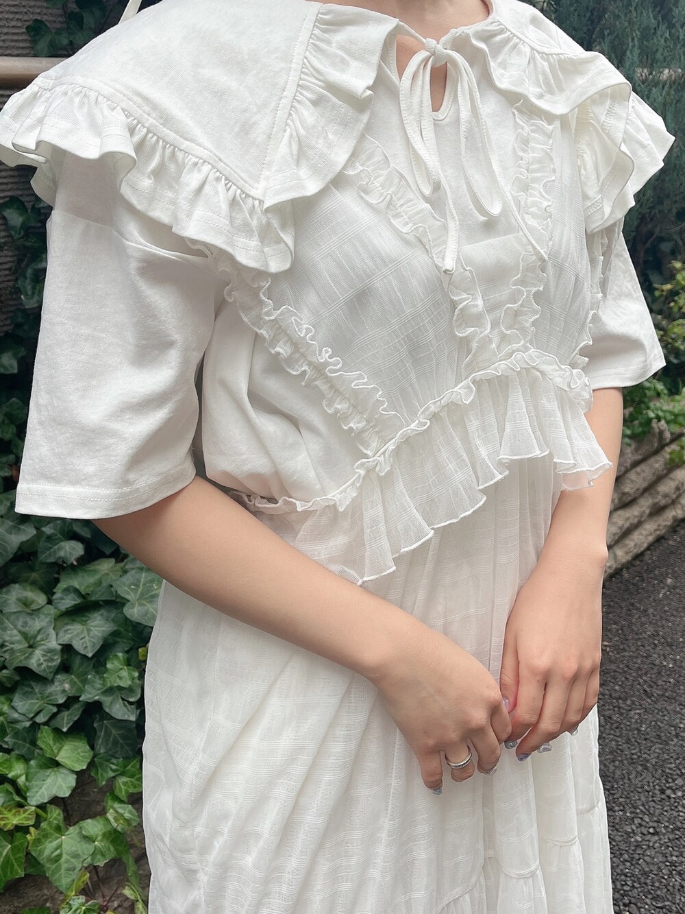 ホワイト系のパンプス、ホワイト系のワンピース、ホワイト系のTシャツ/カットソーを着用したレディースの春コーディネートの6枚目の写真