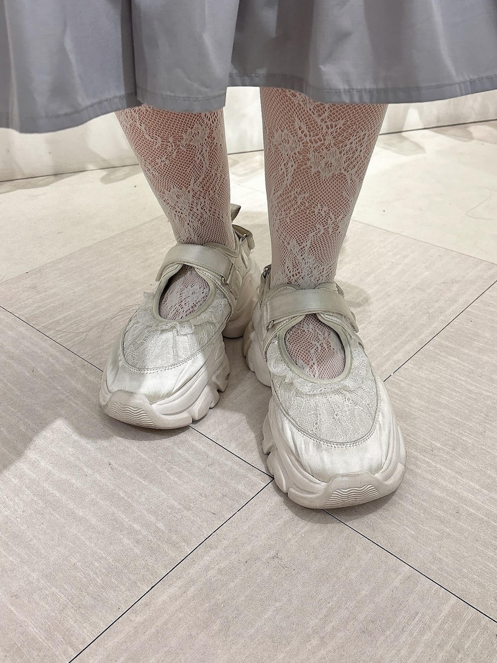 グレー系のスウェット、ホワイト系のダウンジャケット/コート、ホワイト系のショルダーバッグを着用したレディースの冬コーディネートの9枚目の写真