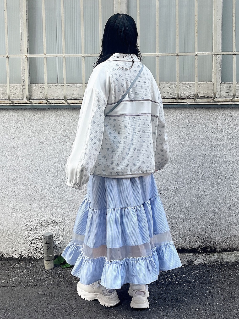 ホワイト系のスウェット、ブルー系のジャージ、ブルー系のショルダーバッグを着用したレディースの春コーディネートの4枚目の写真