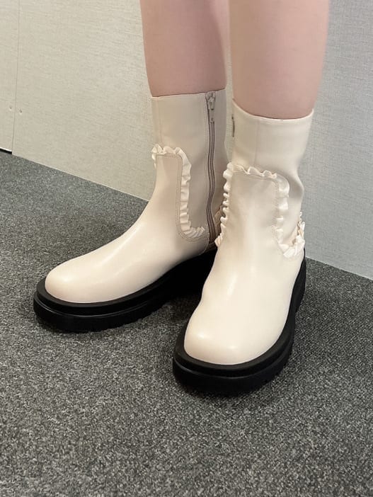 ブルー系のデニムジャケット、ホワイト系のブーツ、ホワイト系のボストンバッグを着用したレディースの夏コーディネートの9枚目の写真