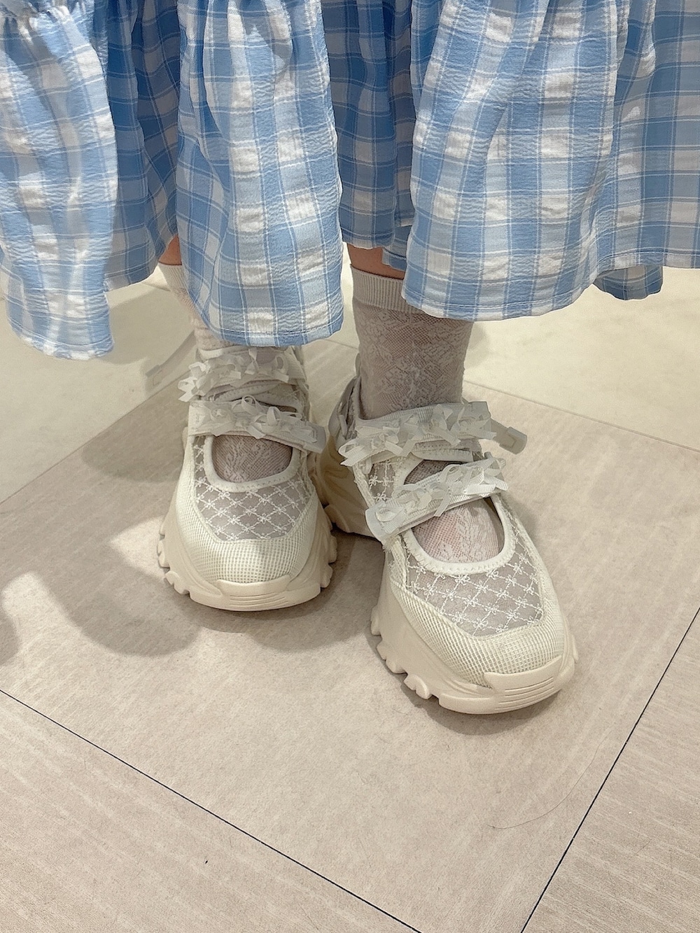 ホワイト系のキャミソール、ブルー系のワンピース、ホワイト系のスニーカーを着用したレディースの春コーディネートの8枚目の写真