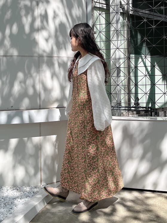 グリーン系のノーカラーコート、ベージュ系のパンプス、ホワイト系のシャツ/ブラウスを着用したレディースの秋コーディネートの3枚目の写真