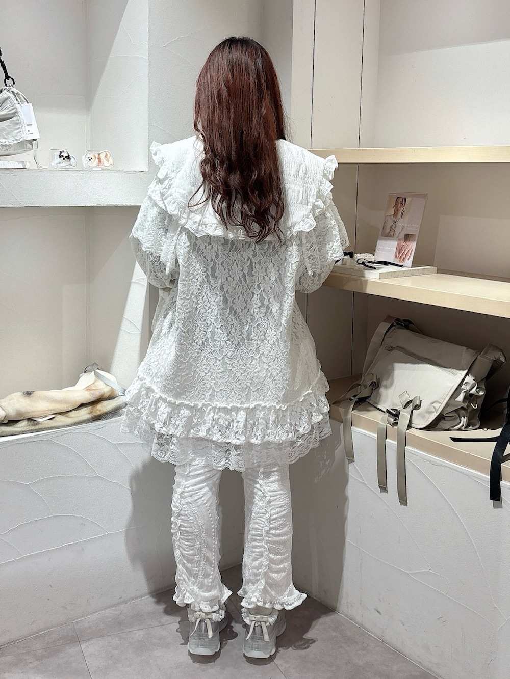 グレー系のワンピース、ホワイト系のその他パンツ、ブルー系のスニーカーを着用したレディースの冬コーディネートの3枚目の写真