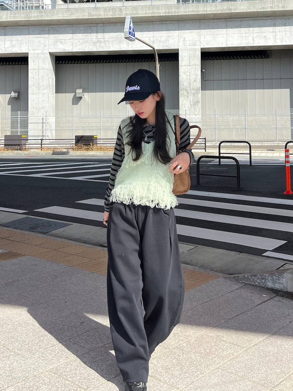 ブラック系のTシャツ/カットソー、ブラック系のスウェットパンツ、ブラウン系のボストンバッグを着用したレディースの冬コーディネートの3枚目の写真