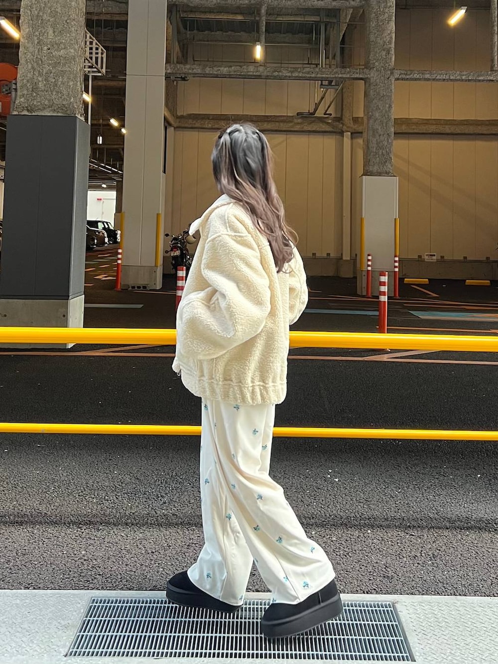 ブラック系のブーツ、ホワイト系のブルゾン、ブラック系のTシャツ/カットソーを着用したレディースの冬コーディネートの5枚目の写真