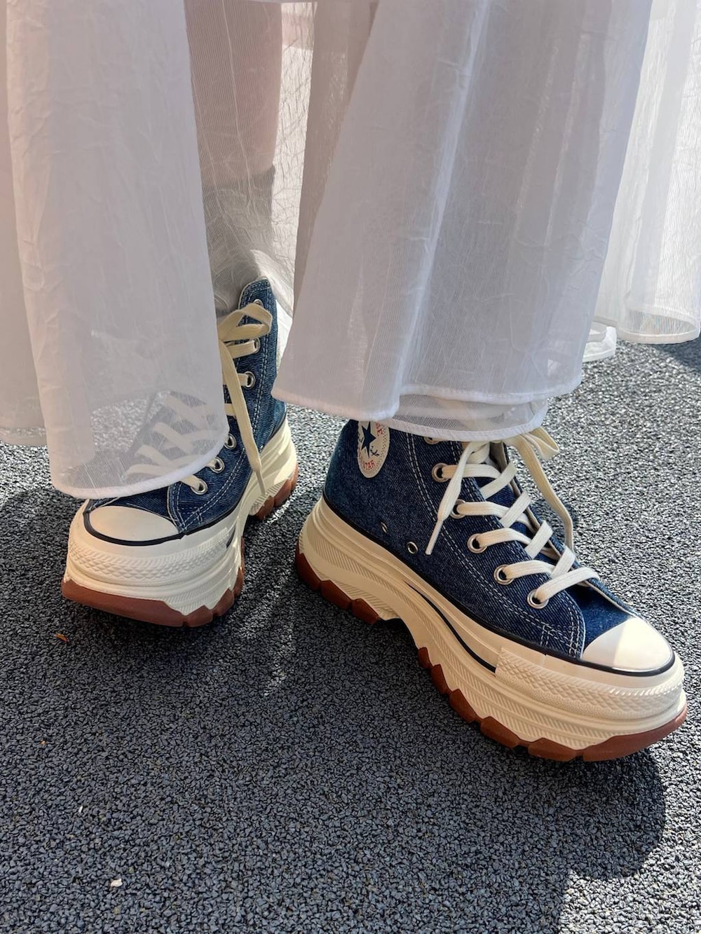 ブルー系のスニーカー、ホワイト系のカーディガン/ボレロ、ホワイト系のスカートを着用したレディースの春コーディネートの5枚目の写真