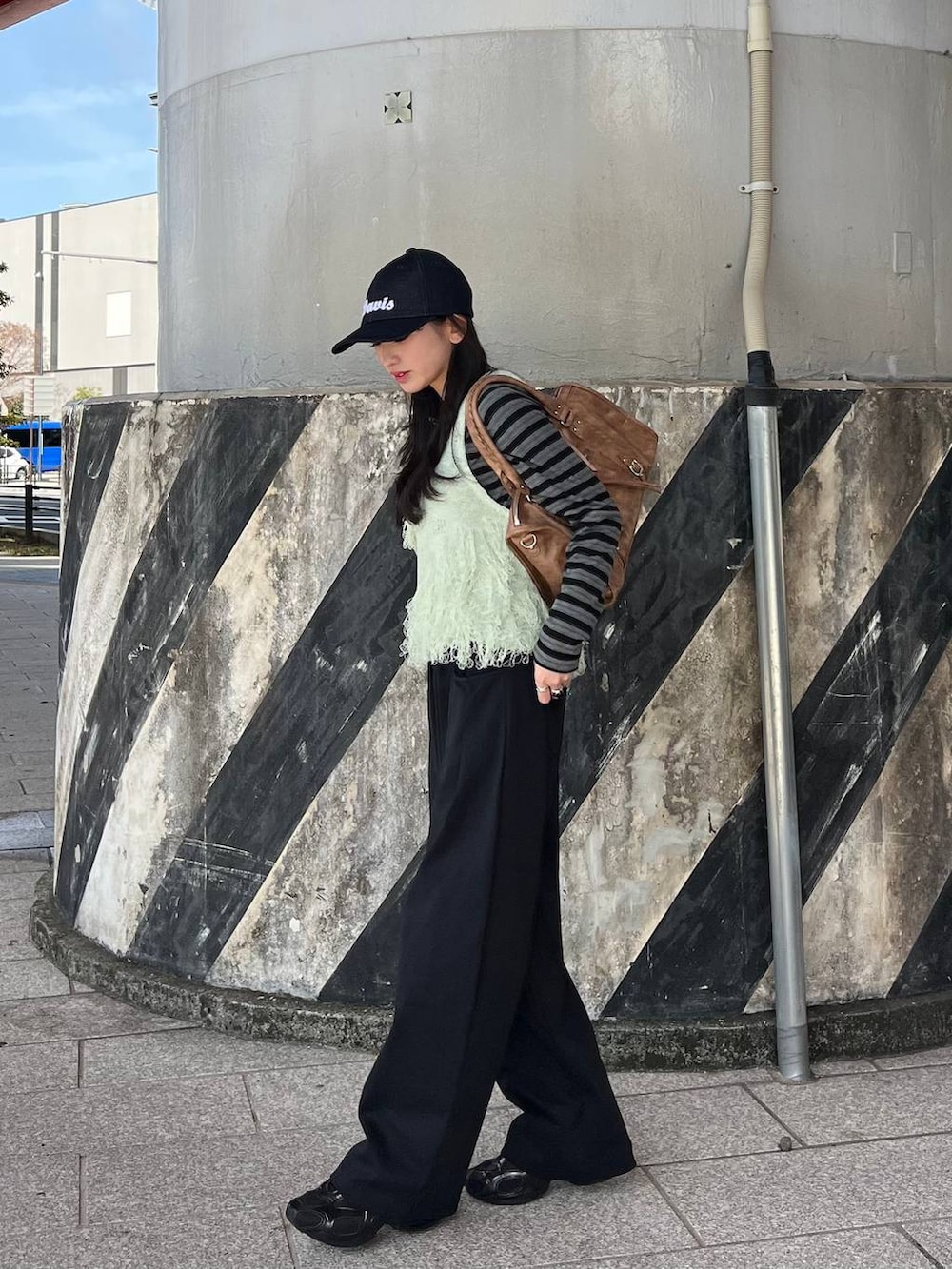 ブラック系のTシャツ/カットソー、ブラック系のスウェットパンツ、ブラウン系のボストンバッグを着用したレディースの冬コーディネートの6枚目の写真