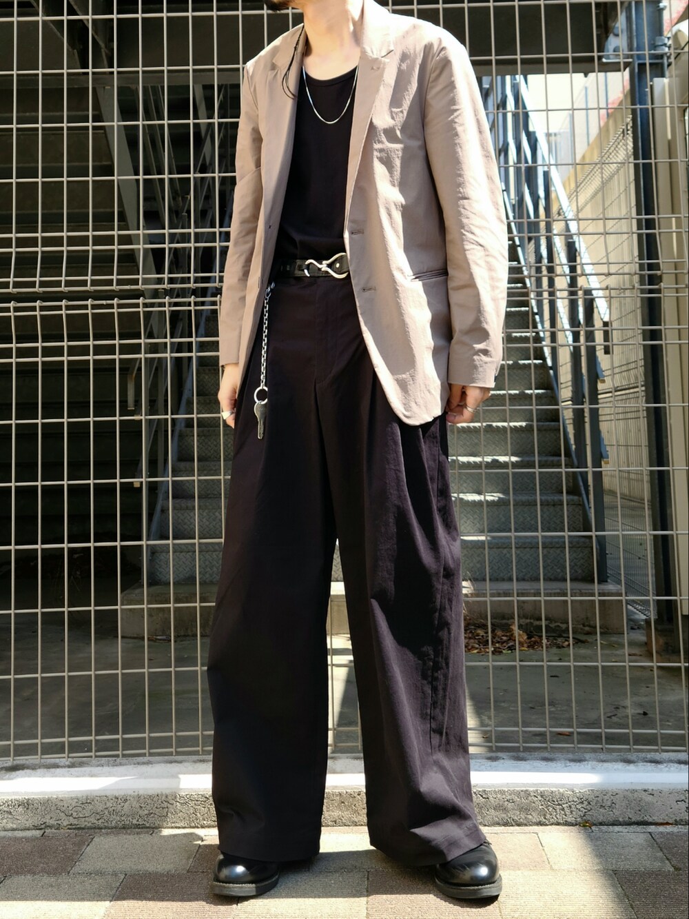 ベージュ系のテーラードジャケット、ベージュ系のその他パンツ、ブラック系のタンクトップを着用したメンズの春コーディネートの5枚目の写真