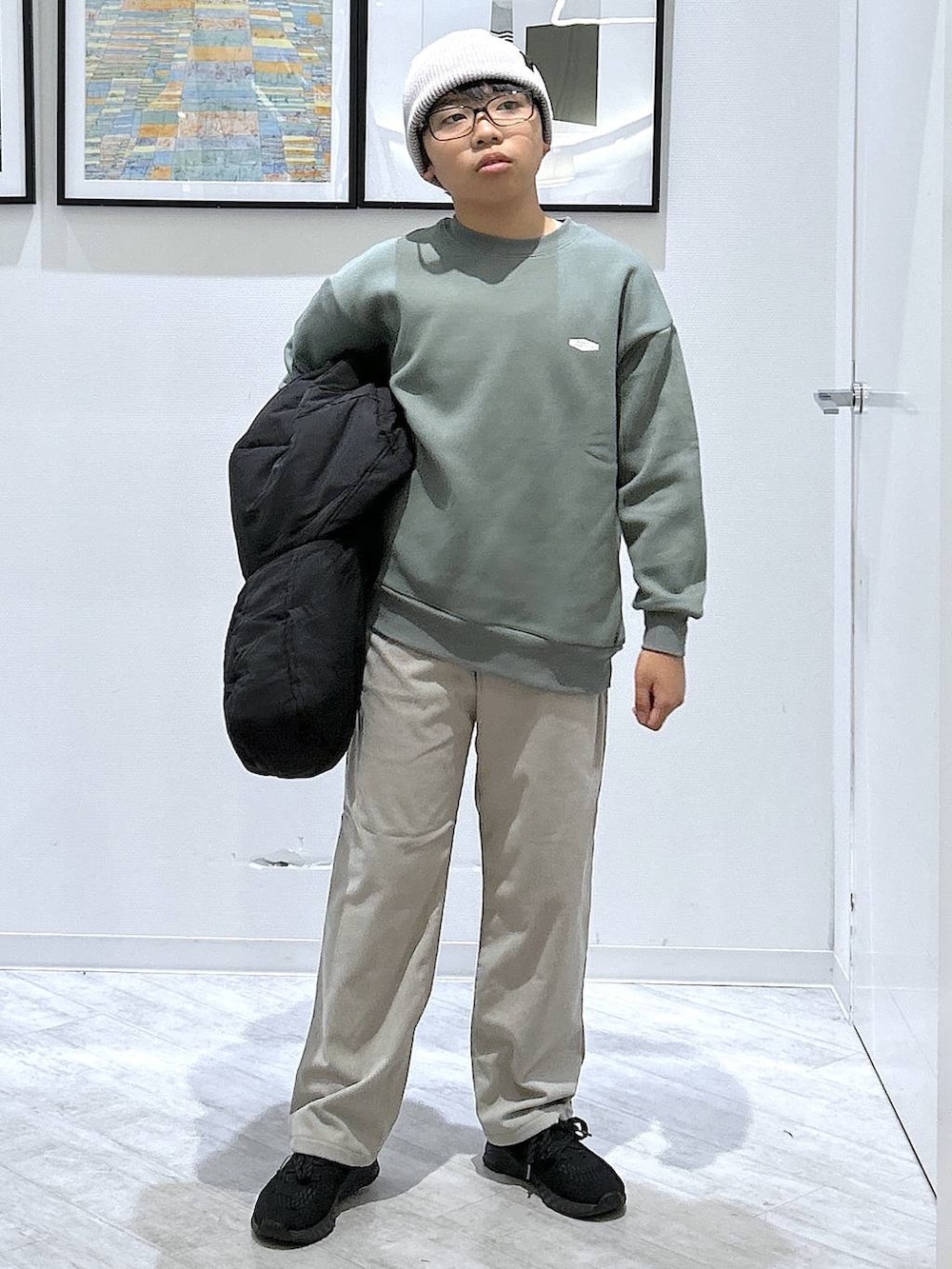 ブラック系のブルゾン、グレー系のその他パンツ、グリーン系のスウェットを着用したキッズの秋コーディネートの7枚目の写真