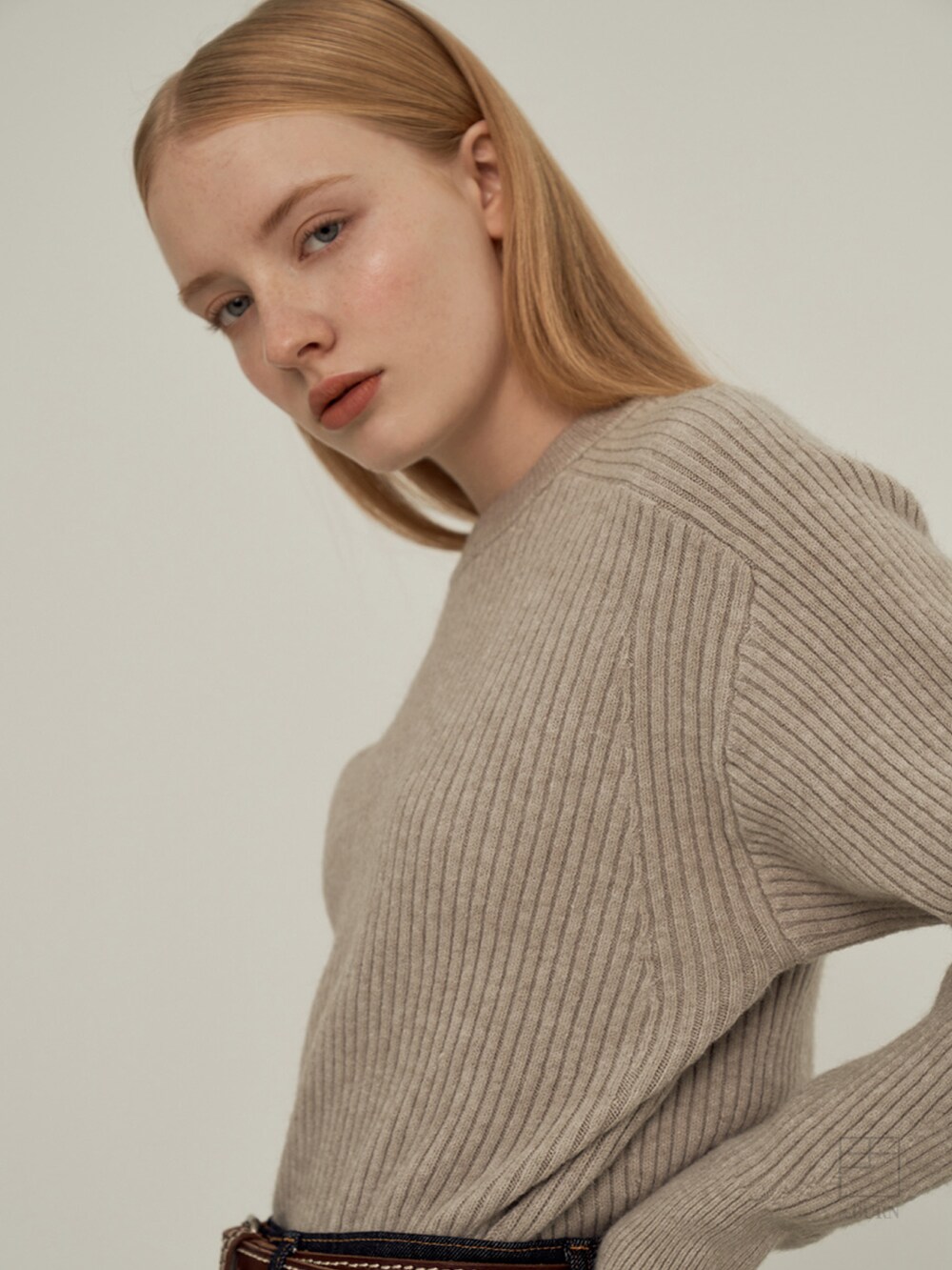 ベージュ系のニット/セーターを着用したレディースの冬コーディネートの2枚目の写真