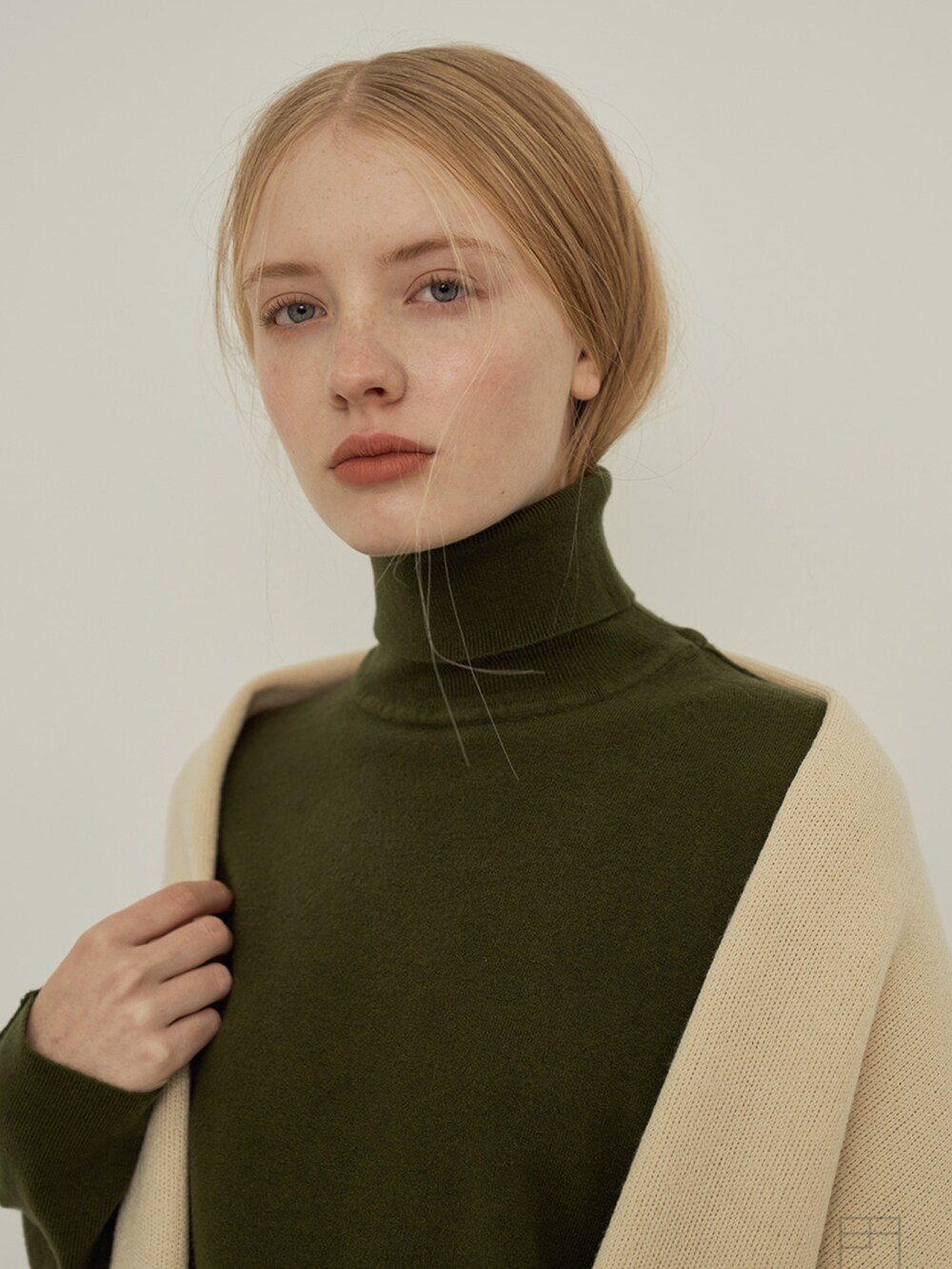 グリーン系のニット/セーターを着用したレディースの冬コーディネートの3枚目の写真