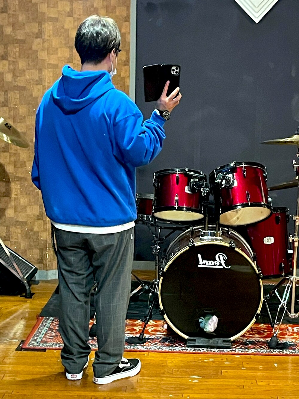 ブルー系のパーカー、ブルー系のスラックス、ブラック系のスニーカーを着用したメンズの秋コーディネートの3枚目の写真