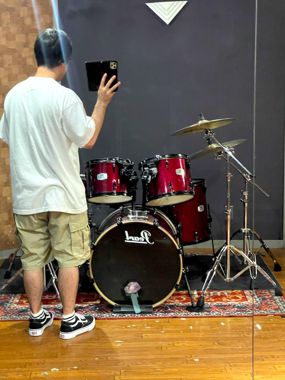 ホワイト系のTシャツ/カットソー、ベージュ系のカーゴパンツ、ブラック系のスニーカーを着用したメンズの夏コーディネートの3枚目の写真