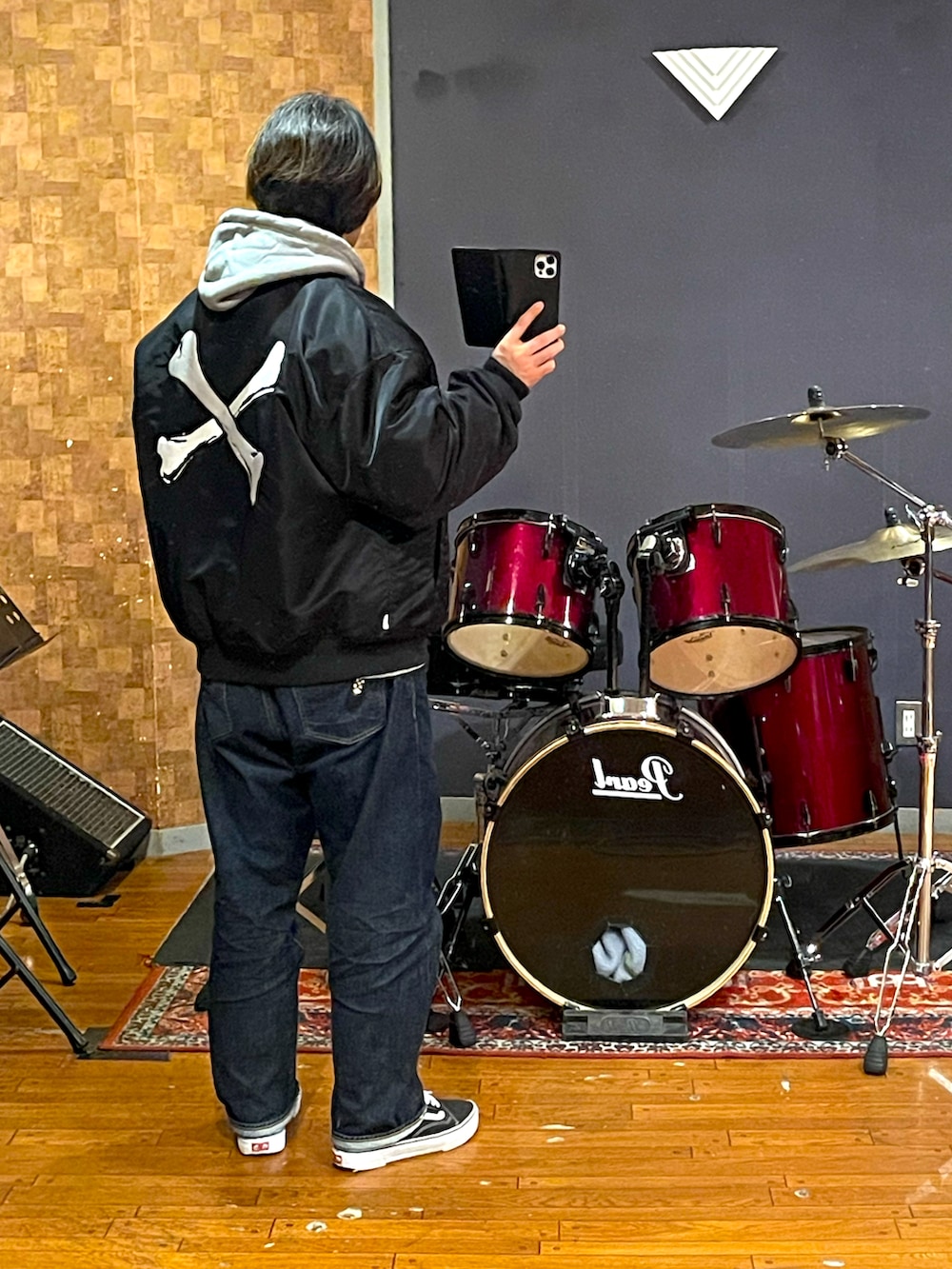 ブラック系のナイロンジャケット、グレー系のパーカー、ブルー系のデニムパンツを着用したメンズの冬コーディネートの2枚目の写真